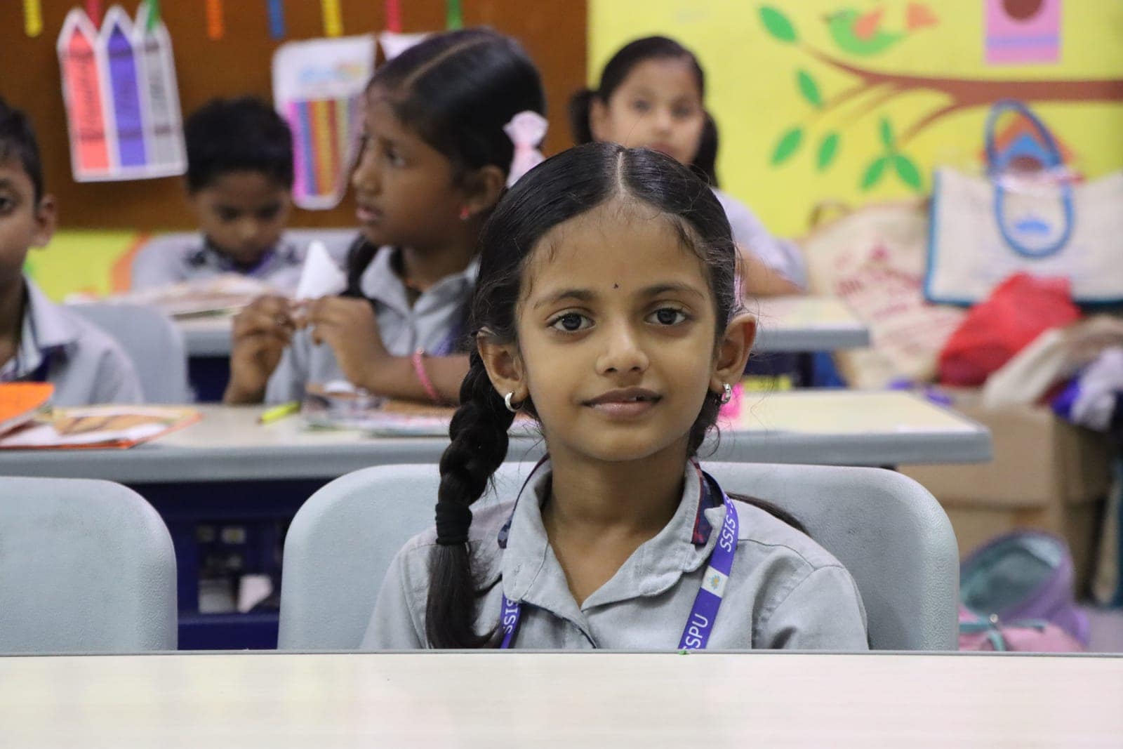 Braids and books in a classroom at Sri Sharada International School