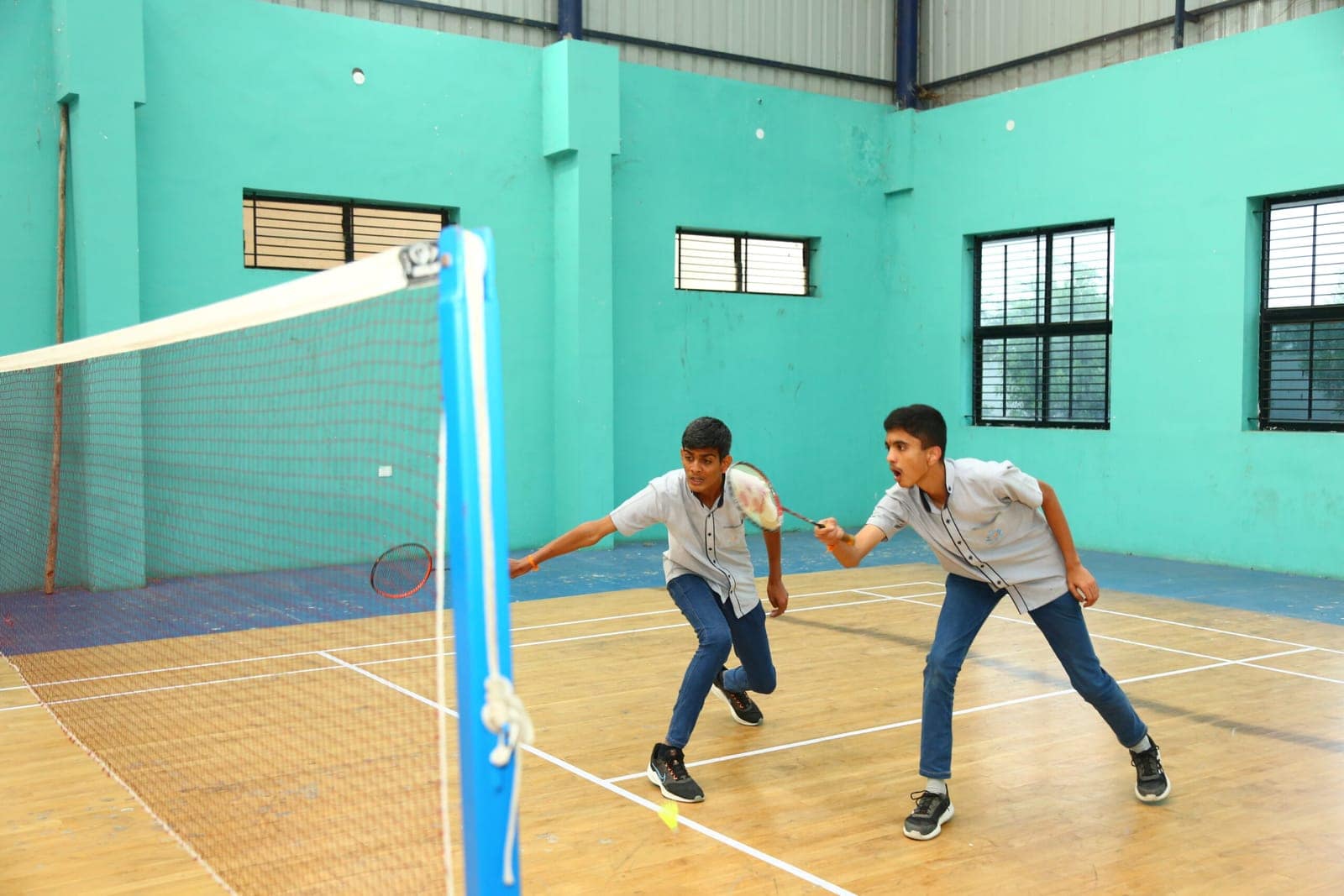 Students playing badminton rally at Sri Sharada International School