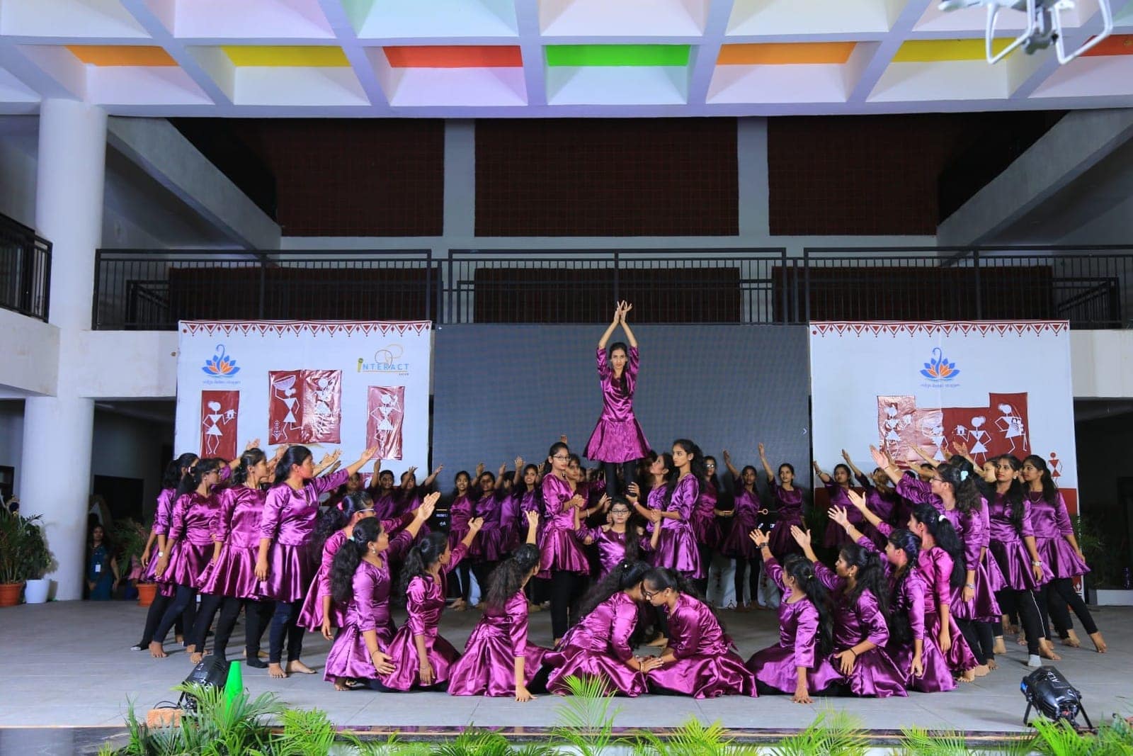Pyramid purple performance on stage at Sri Sharada International School