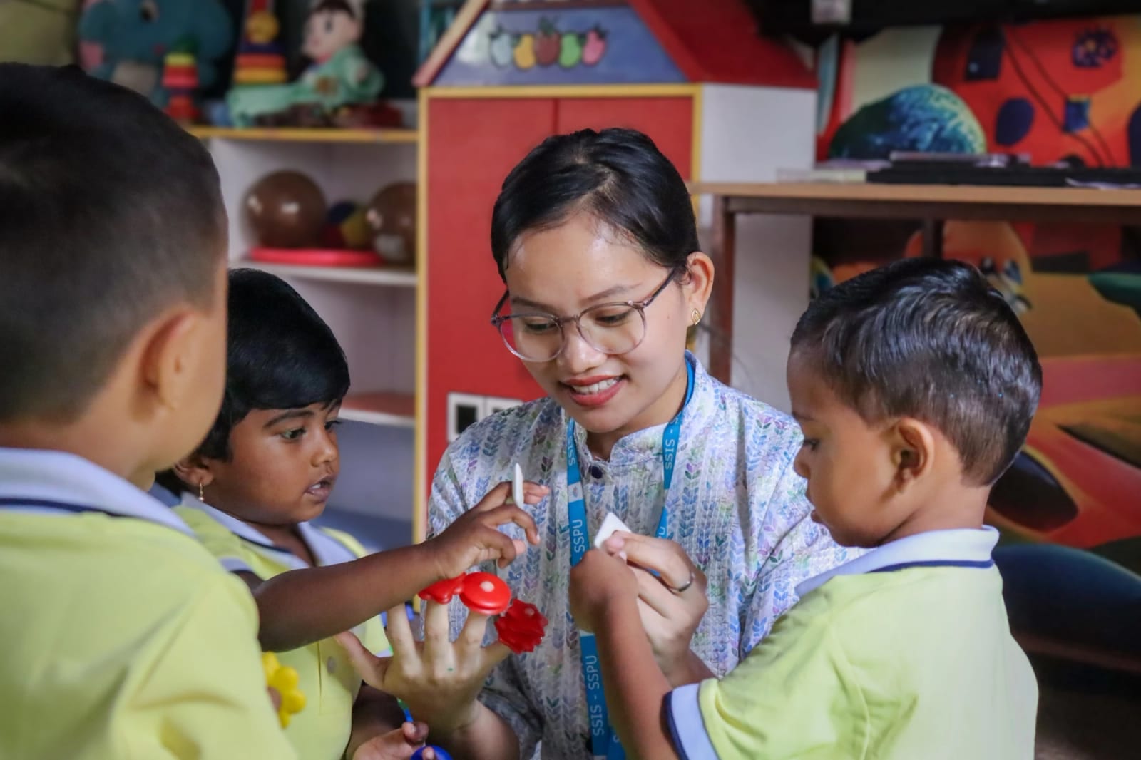 Inside a Sri Sharada Chinnara Loka classroom — a teacher with her littlest learners